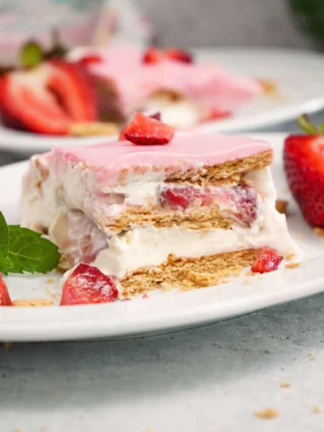 Strawberries N Cream Éclair Cake on white plate.