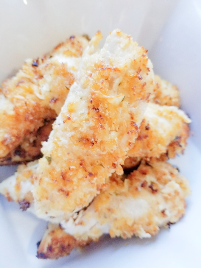air fryer parmesan ranch chicken tenders piled up in dish 