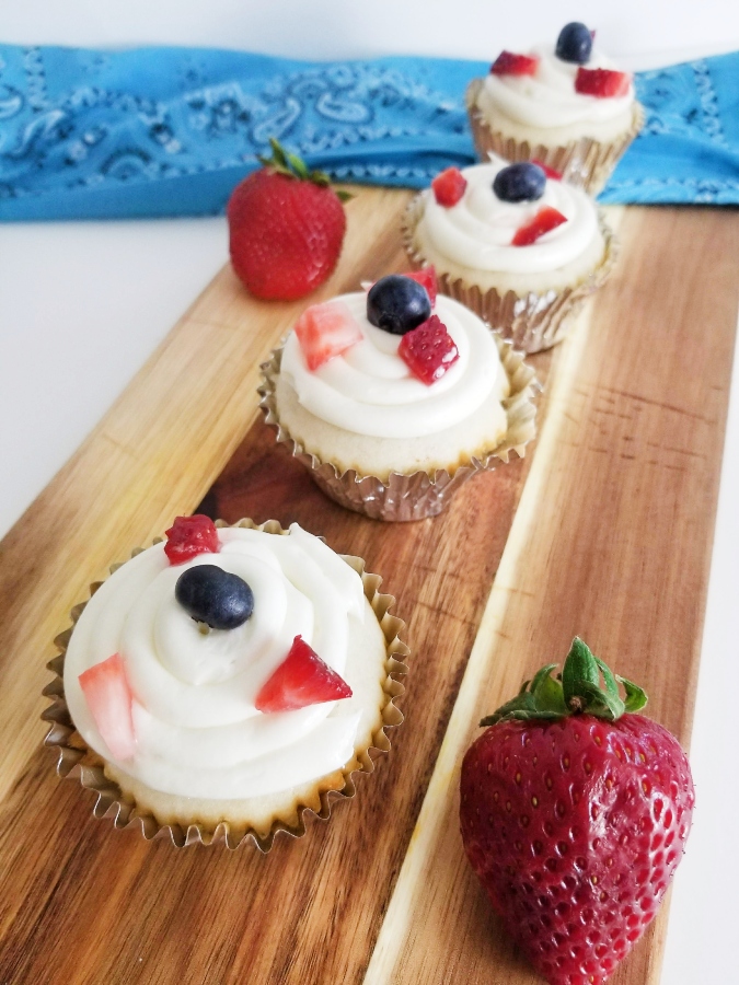 Summer Berry Cupcakes on cutting board with strawberry 