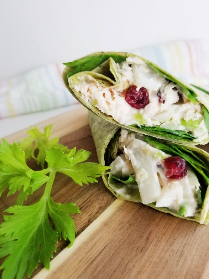Cranberry Chicken Salad Spinach Wraps stacked on cutting board 