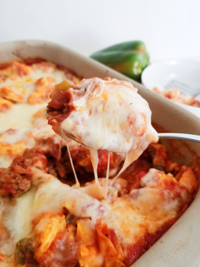 Italian Sausage & Tortellini Bake on spoon with melty cheese 