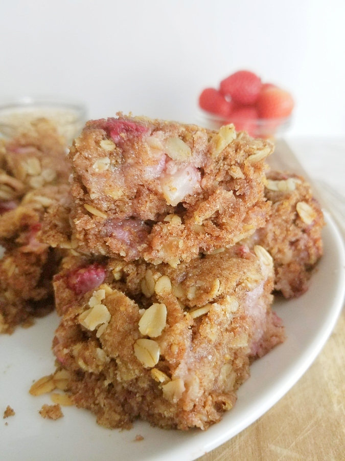 Strawberry Oatmeal Bars stacked on white plate 
