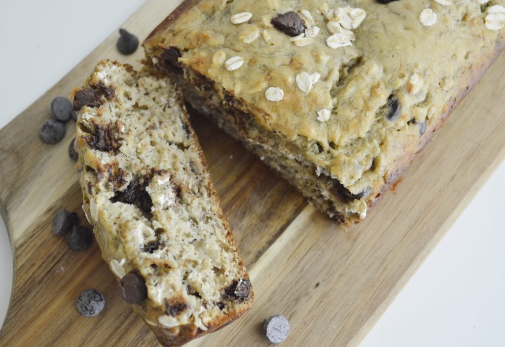Oatmeal Chocolate Chip Banana Bread slice and loaf on cutting board 