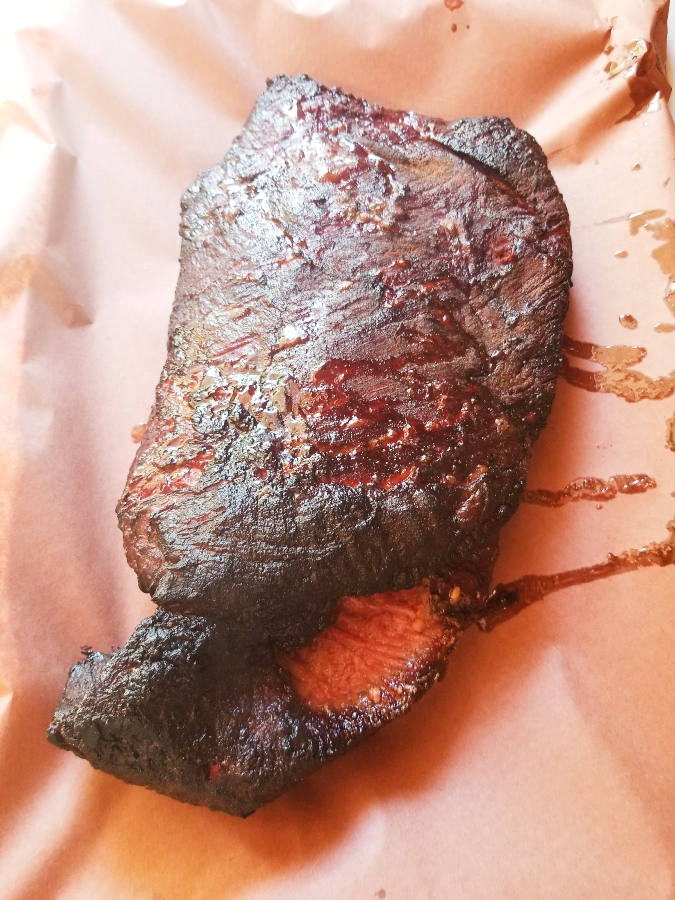 Smoked brisket on butcher paper before wrapped 