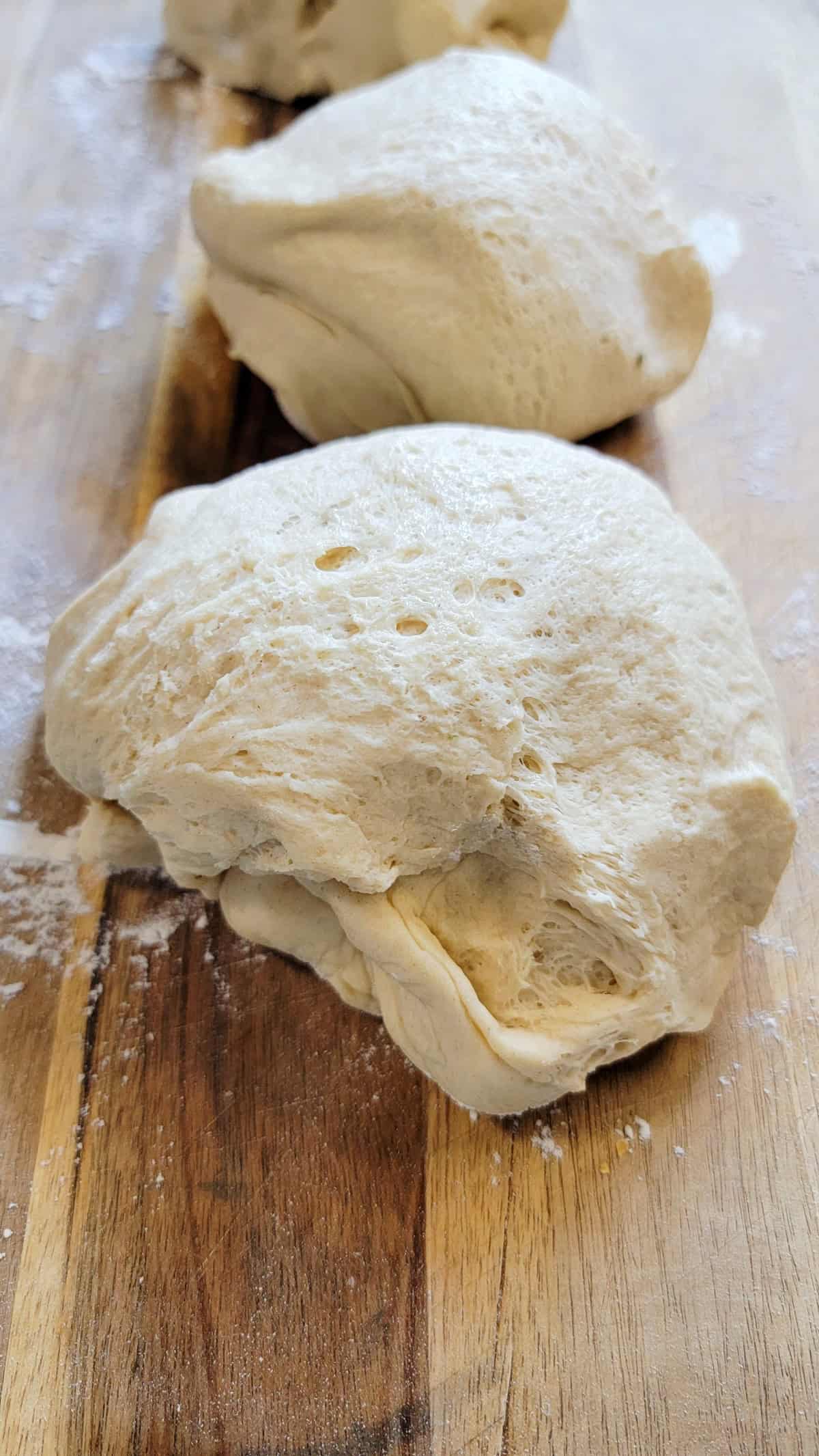 Pizza dough on floured surface