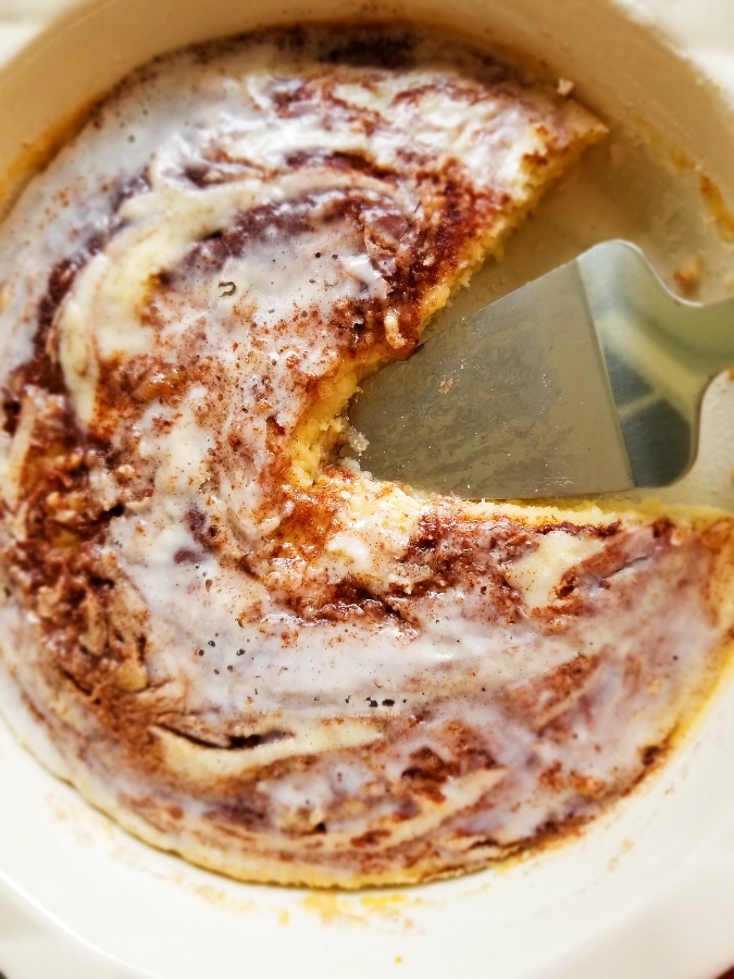 Cinnamon Roll Cake with slice missing 