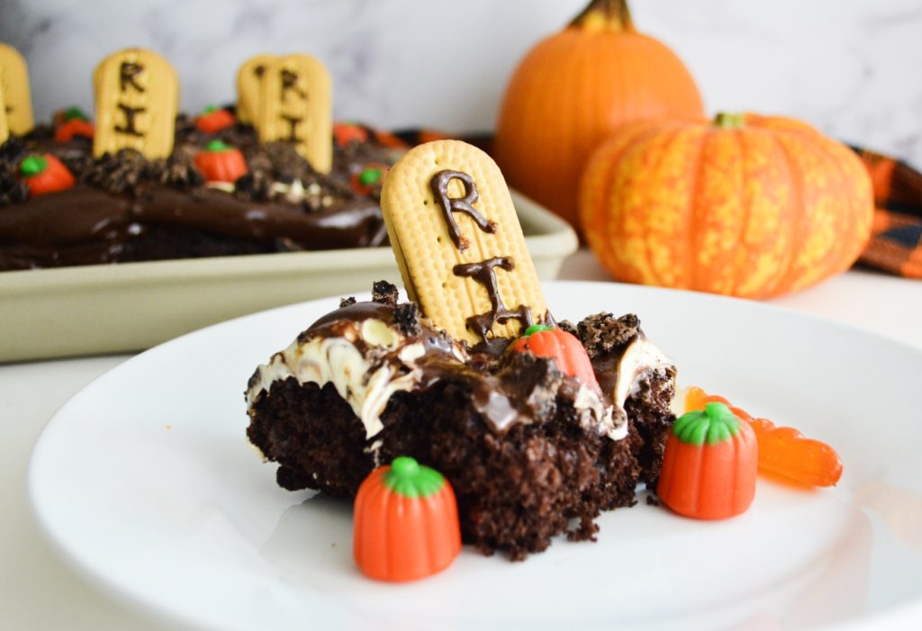 Simple Graveyard Bumpy Cake slice with pumpkins in background 