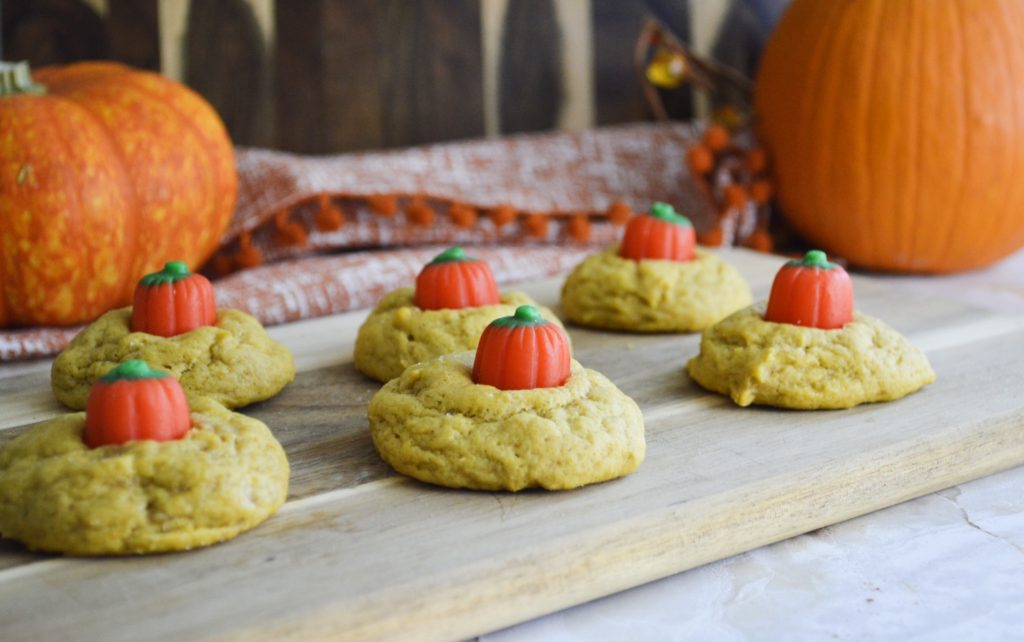 Soft & Chewy Pumpkin Cookies  with pumpkins on cutting board 