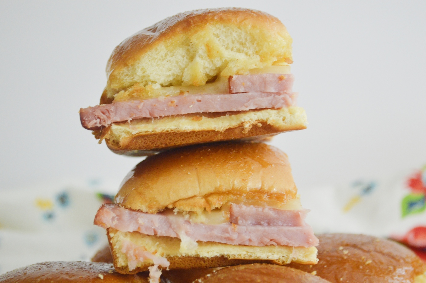 close up of hot honey ham & Swiss sliders 