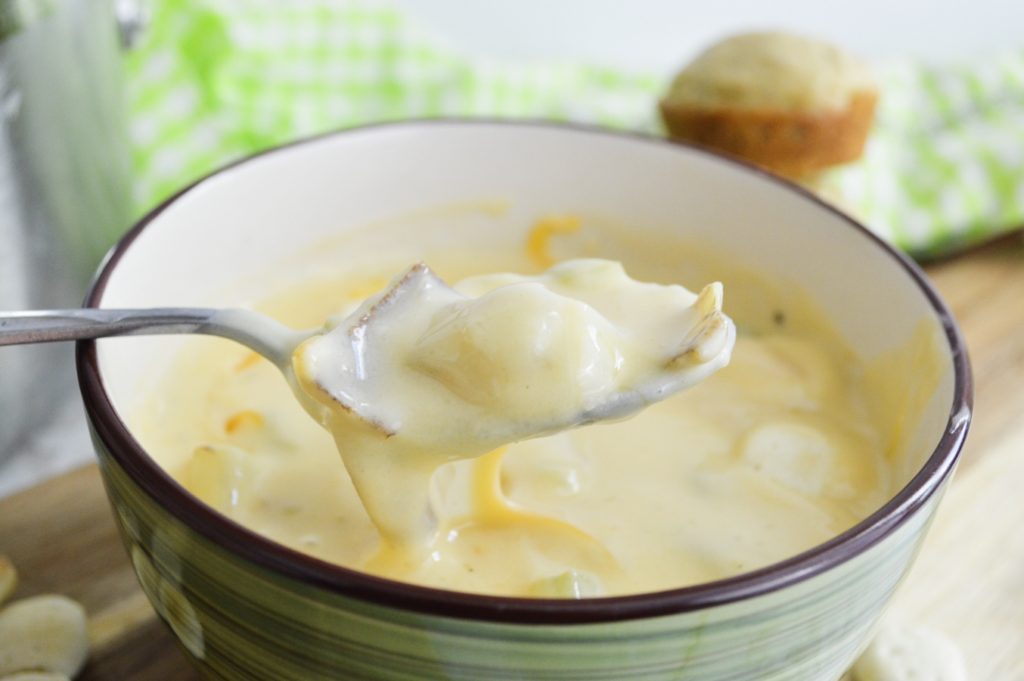 easy cheesy potato soup close up on spoon 