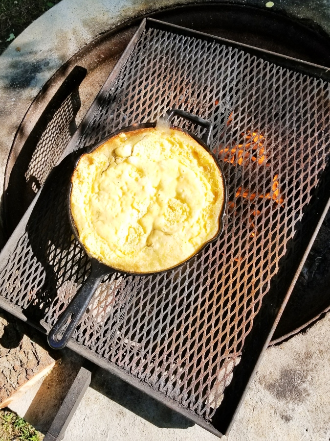cast iron pan over campfire 