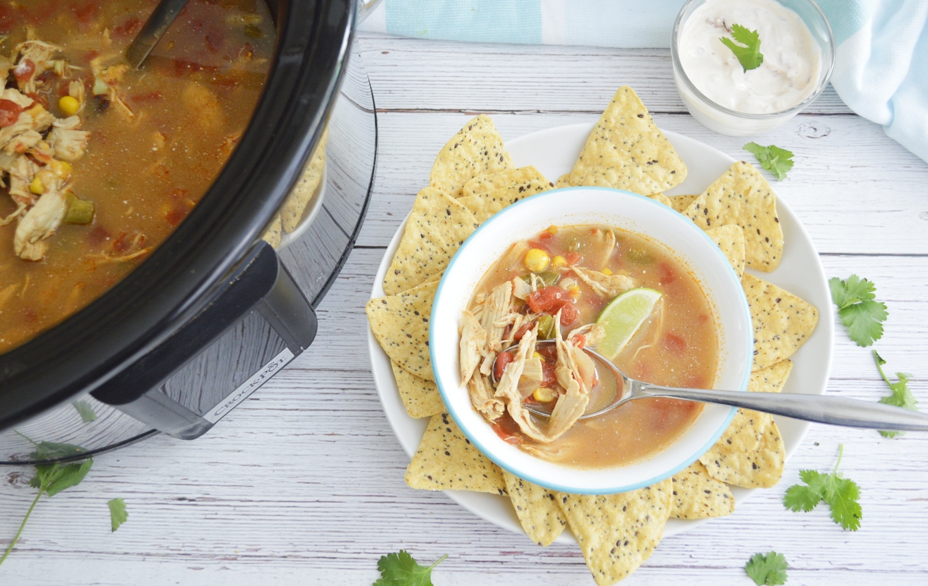 Slow cooker and chicken tortilla soup with spoon 