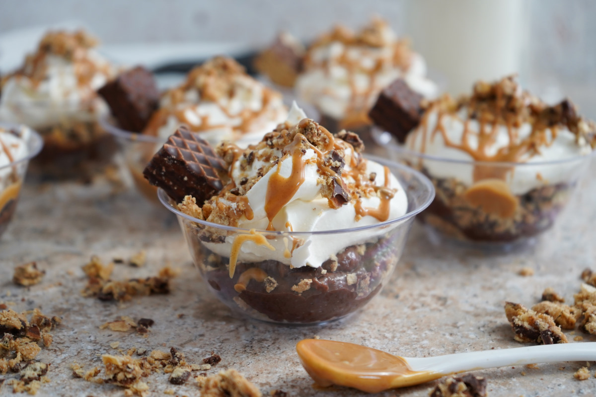 Peanut Butter Chocolate Parfait in cups with white spoon with peanut butter