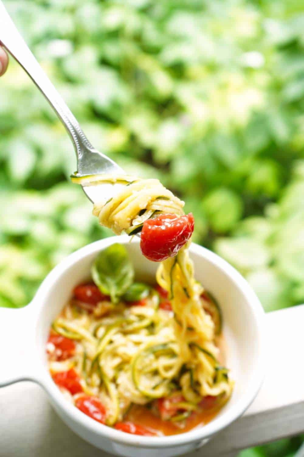 zucchini noodles on fork with tomato