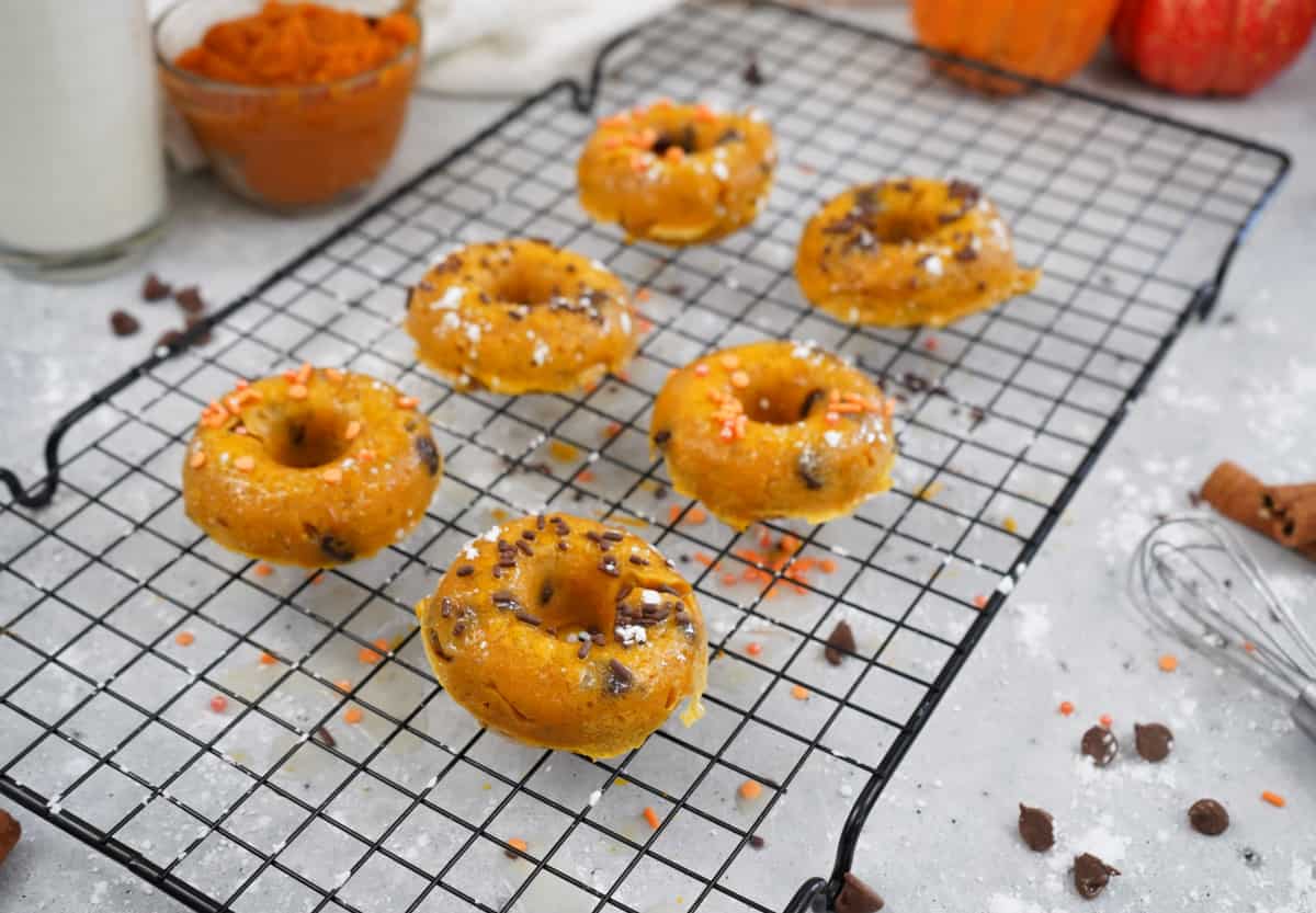 pumpkin donuts on cooling rack 