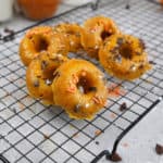 Pumpkin donuts on cooling rack