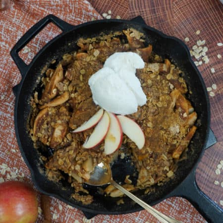 Smoked apple crisp in skillet with spoon
