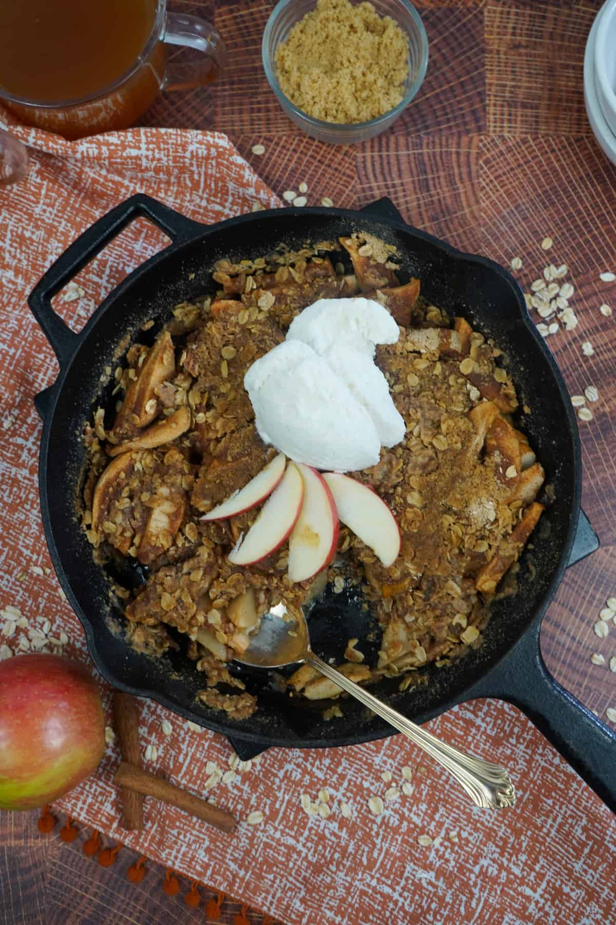 Smoked apple crisp in skillet with spoon