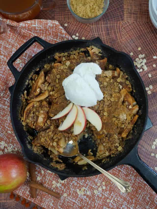 Smoked apple crisp in skillet with spoon