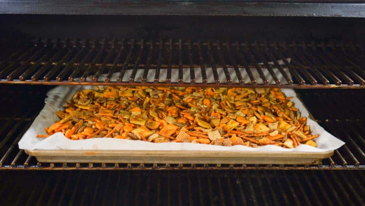 Chex Mix on pan in smoker. 