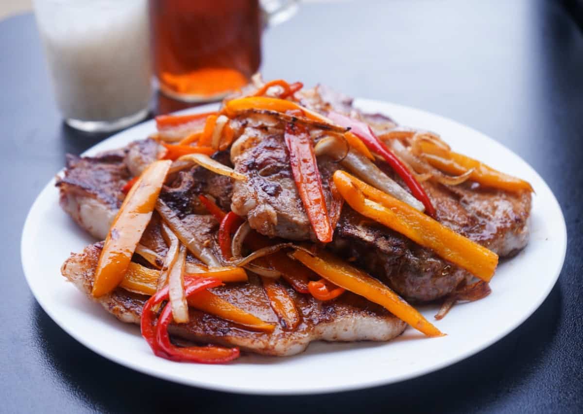 Pork Chops on plate with peppers and onions