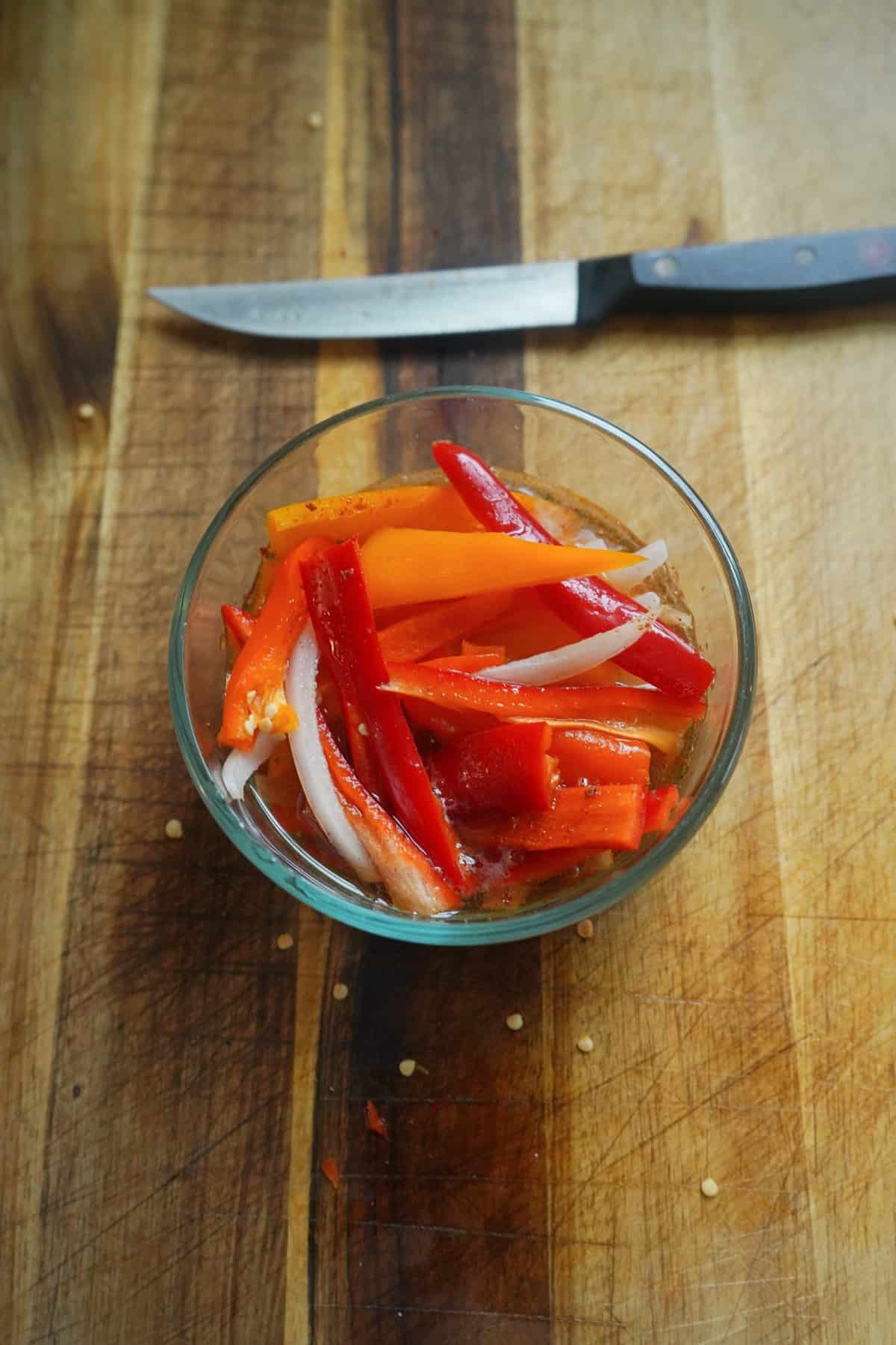 Sliced peppers and onions in beer
