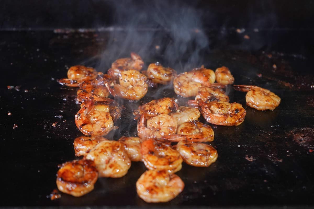 Shrimp cooking on flat top