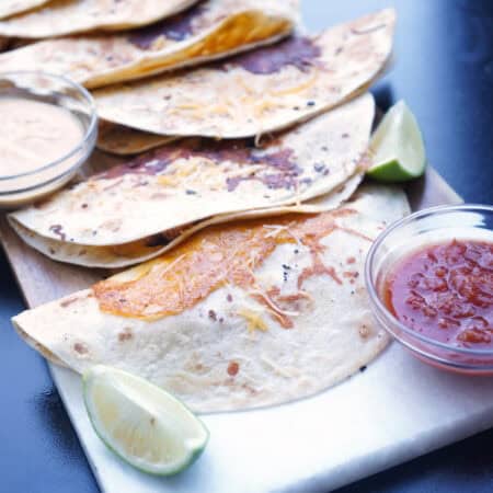 Queso tacos on cutting board