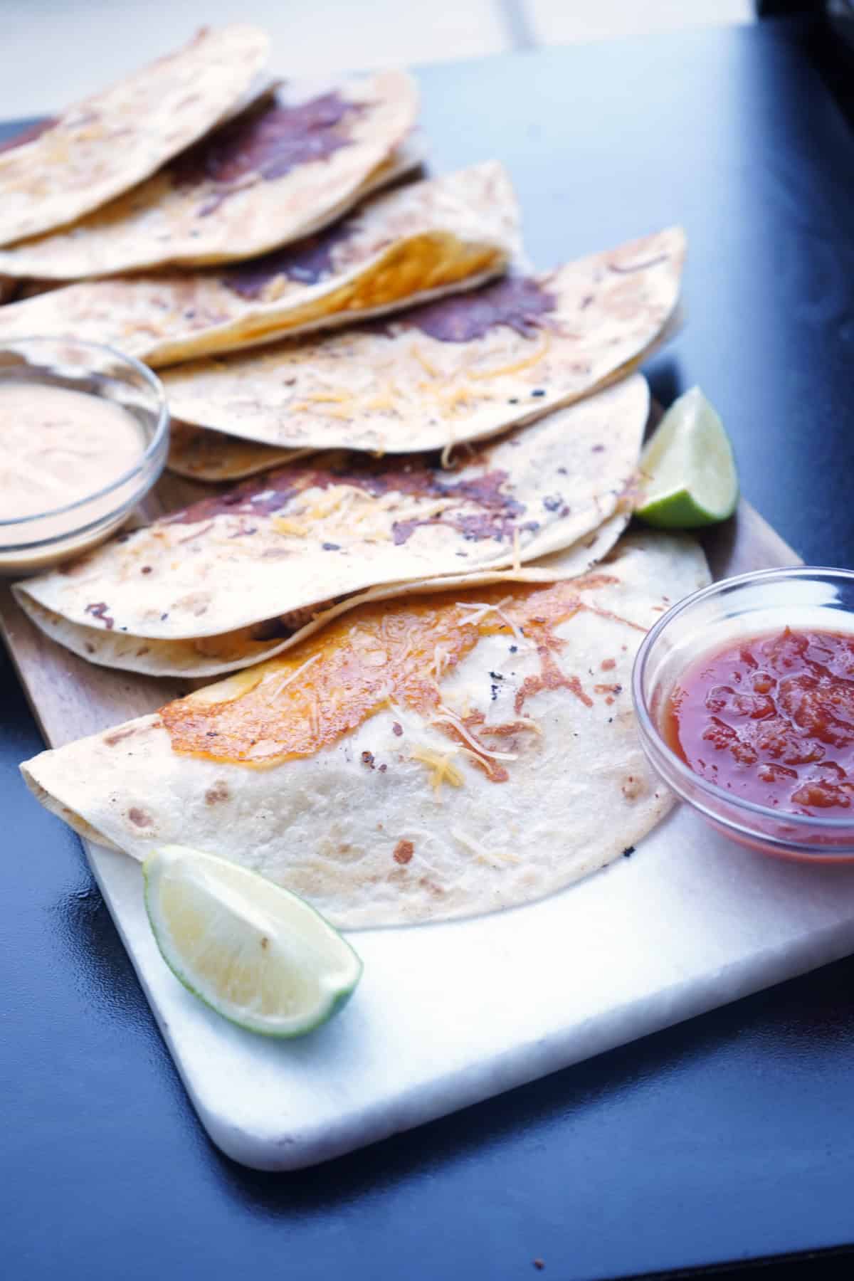 Queso tacos on cutting board