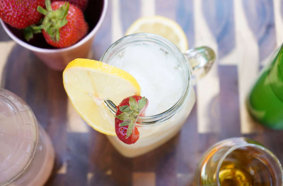 Kentucky mule in glass with lemon and strawberries. 