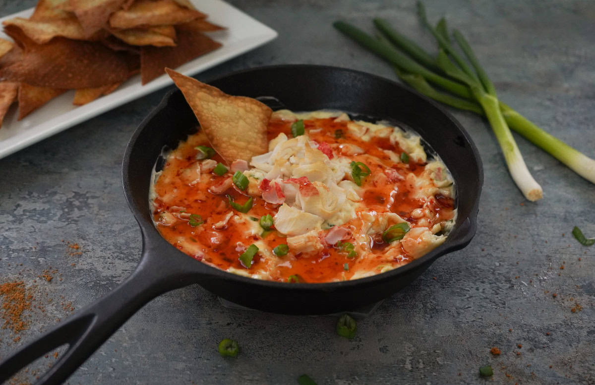 crab ragoon dip in cast iron pan