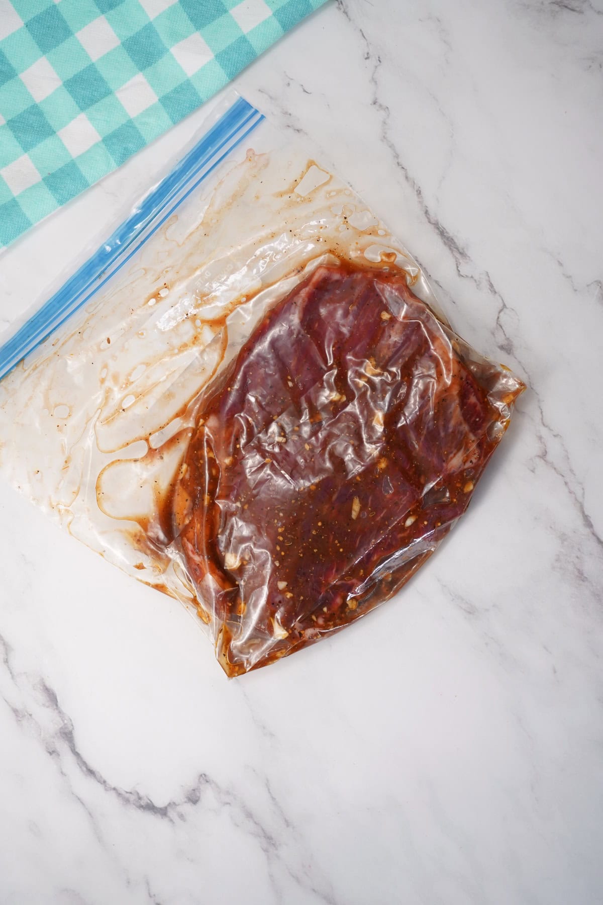 sealed marinated flank steak in bag.