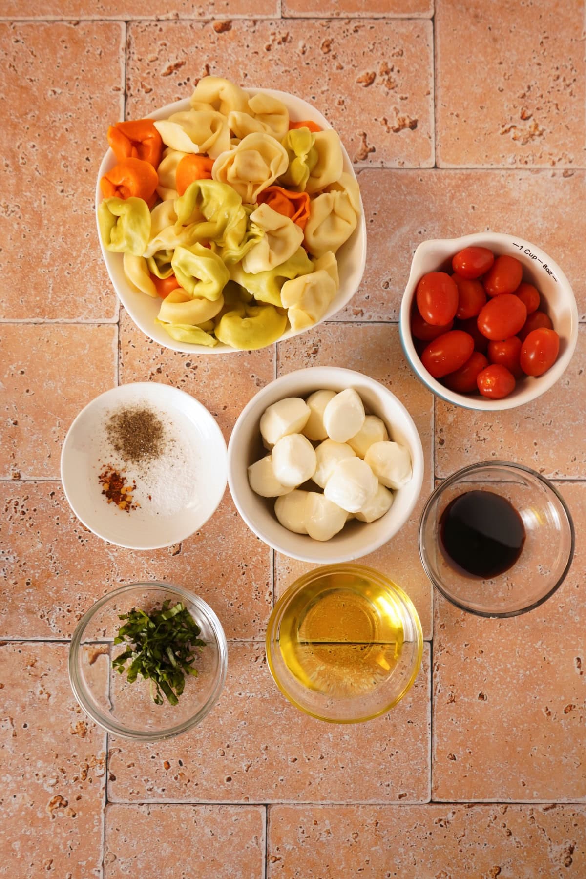 caprese tortellini pasta salad ingredients on table
