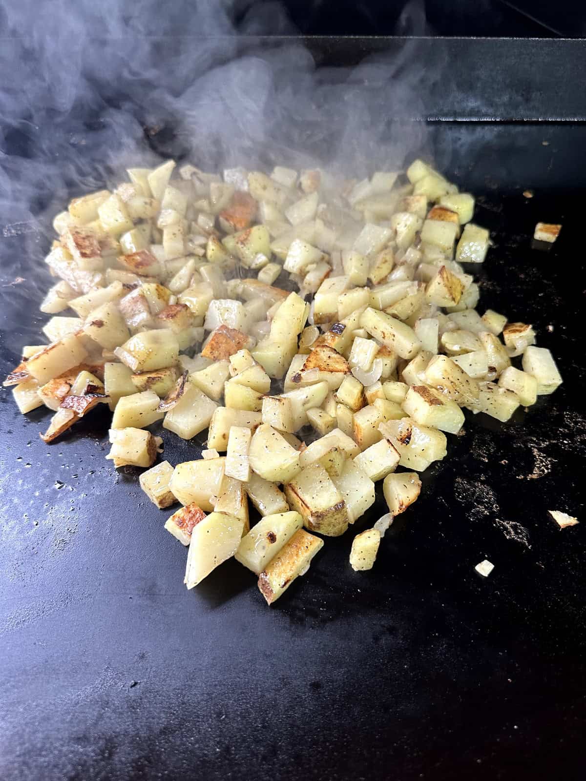 cooking potatoes on a flat top