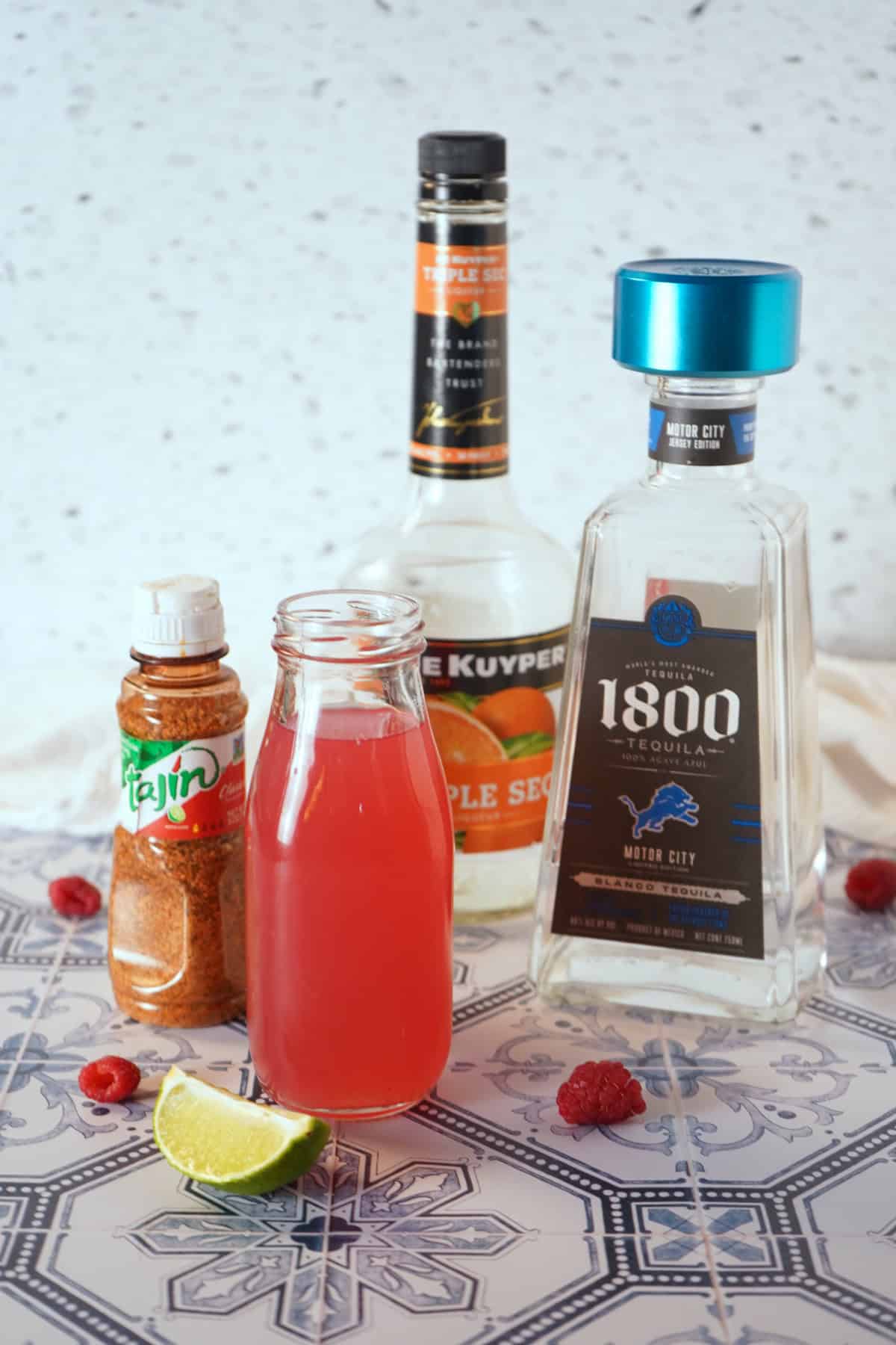 Ingredients needed to make a raspberry lemonade margarita.