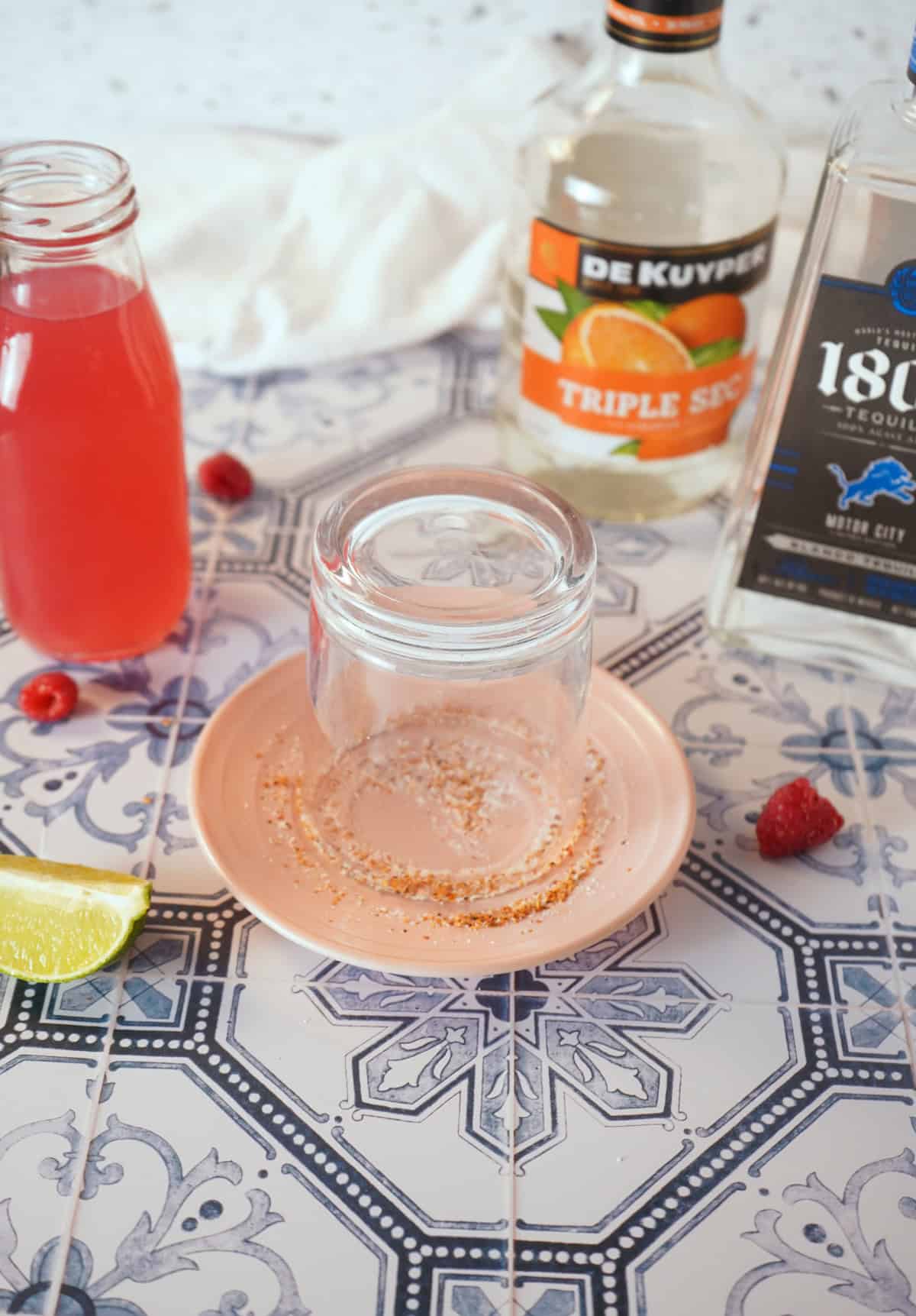 Glass being dipped in Tajin seasoning.