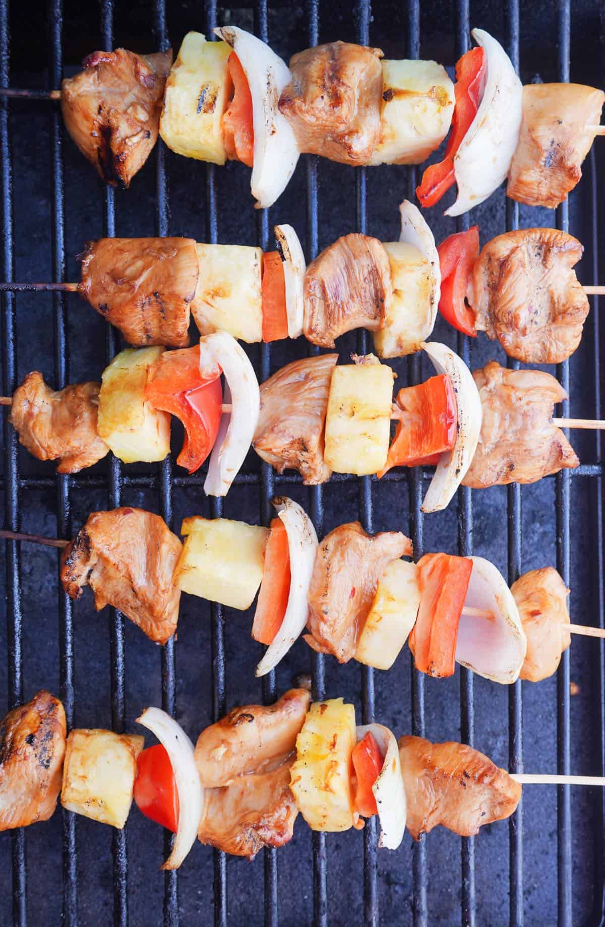 Grilled chicken skewers on grill