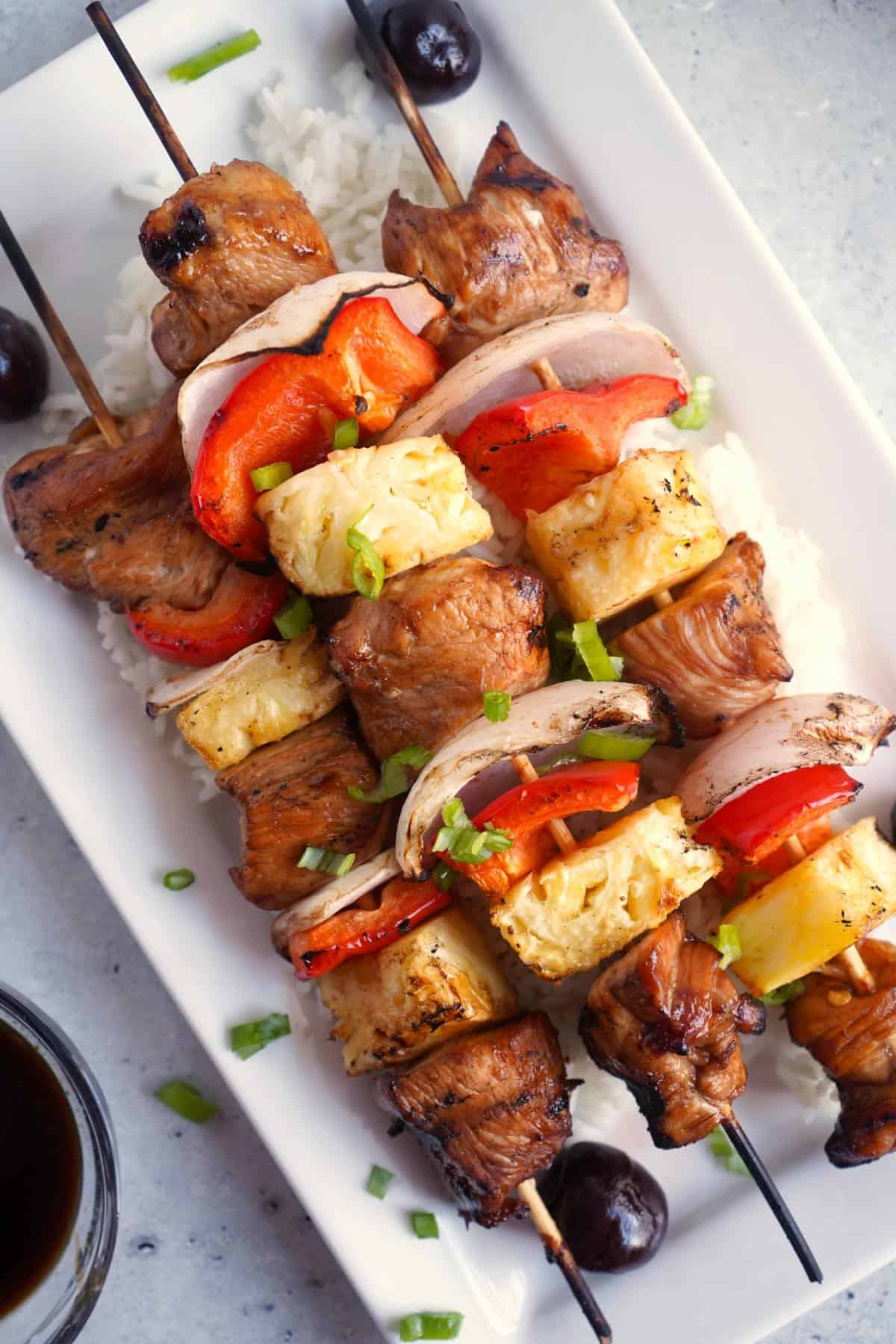 chicken skewers over white rice.