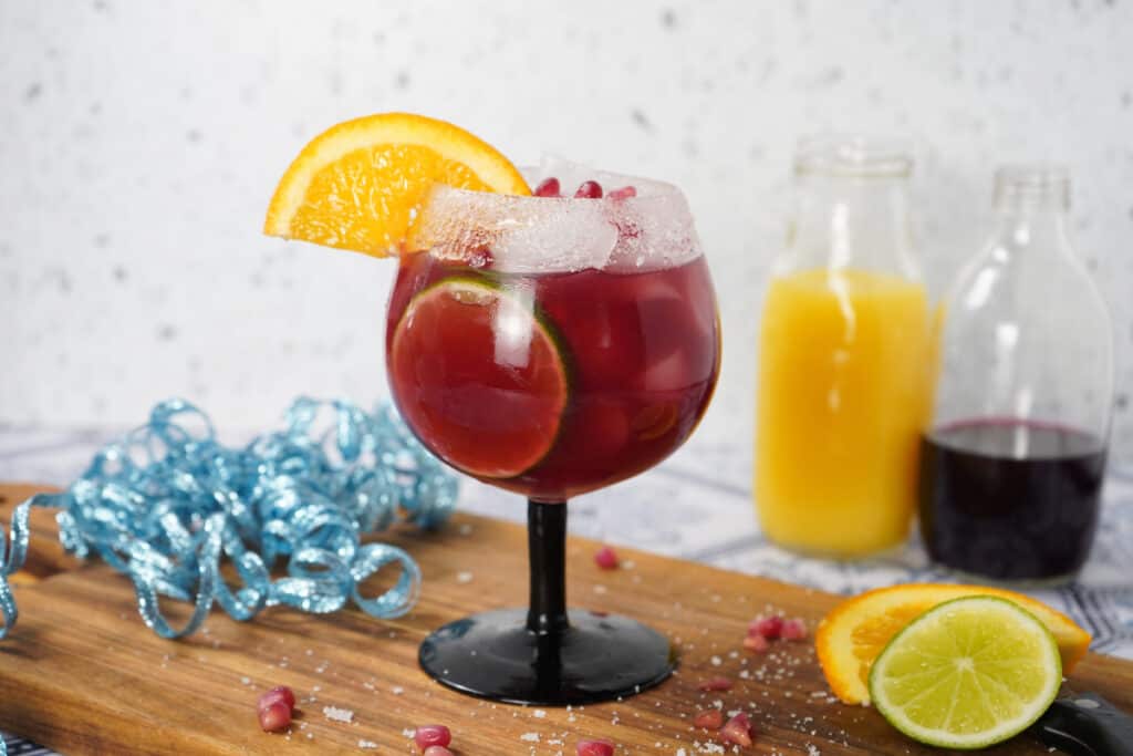 Black stem glass with margarita and orange slice 