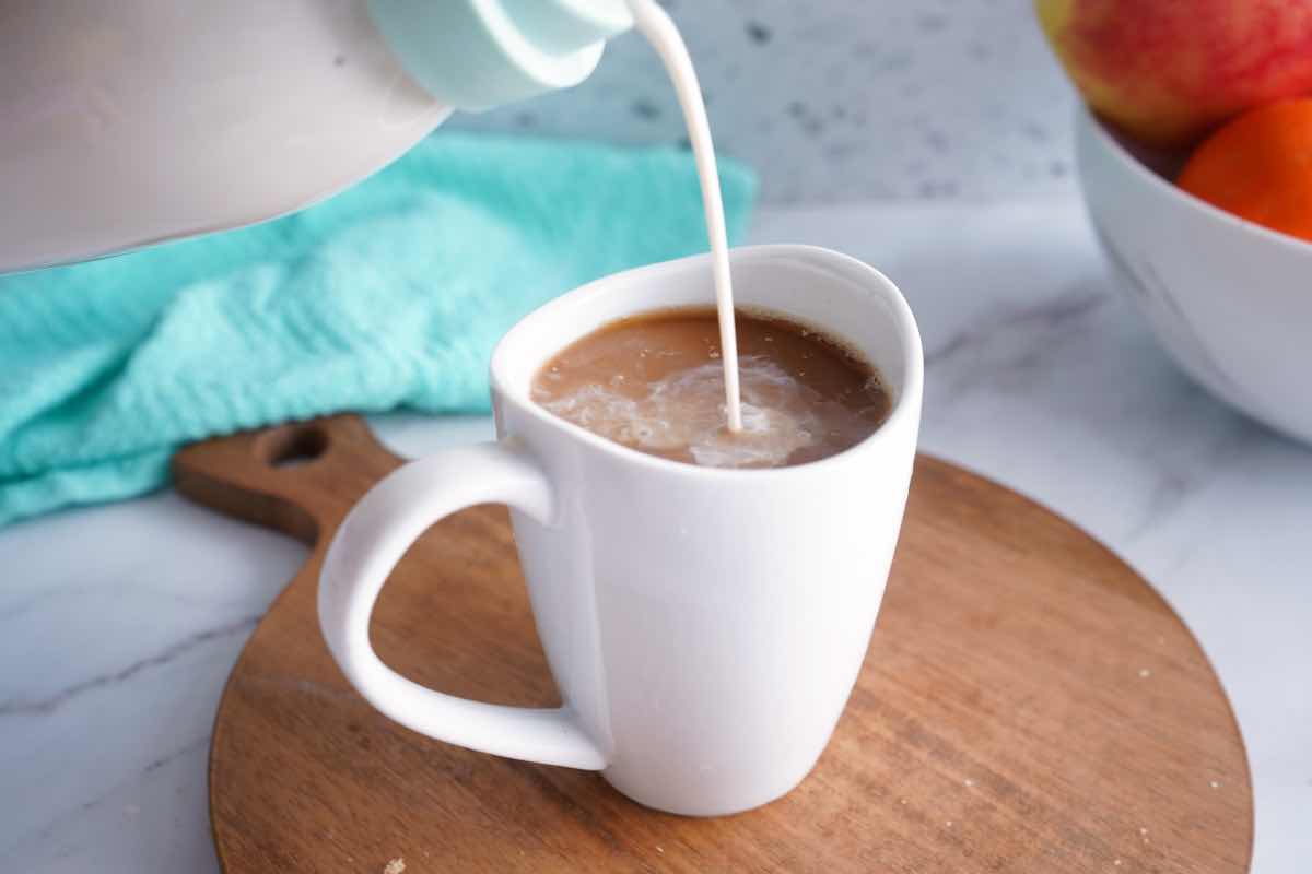 creamer being poured into coffee
