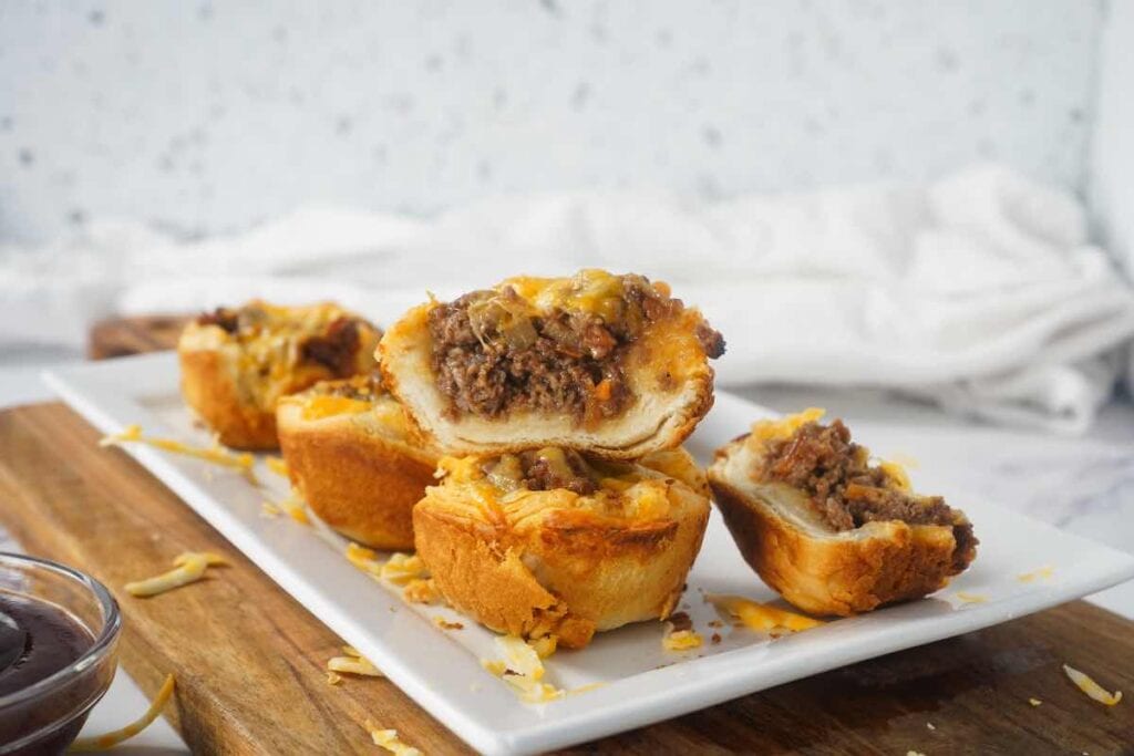 BBQ burger biscuit cups cut open on white platter