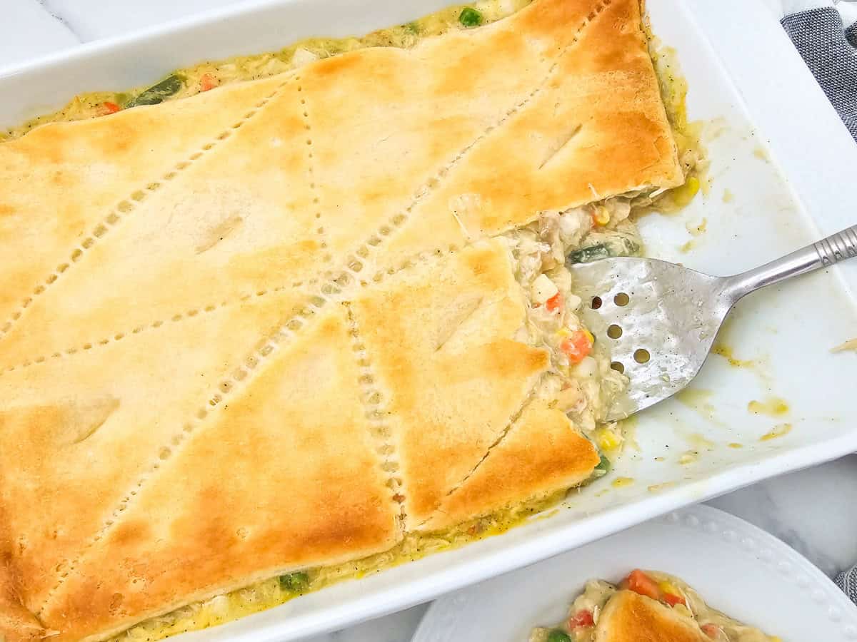 Crescent roll pot pie with chicken in baking dish.