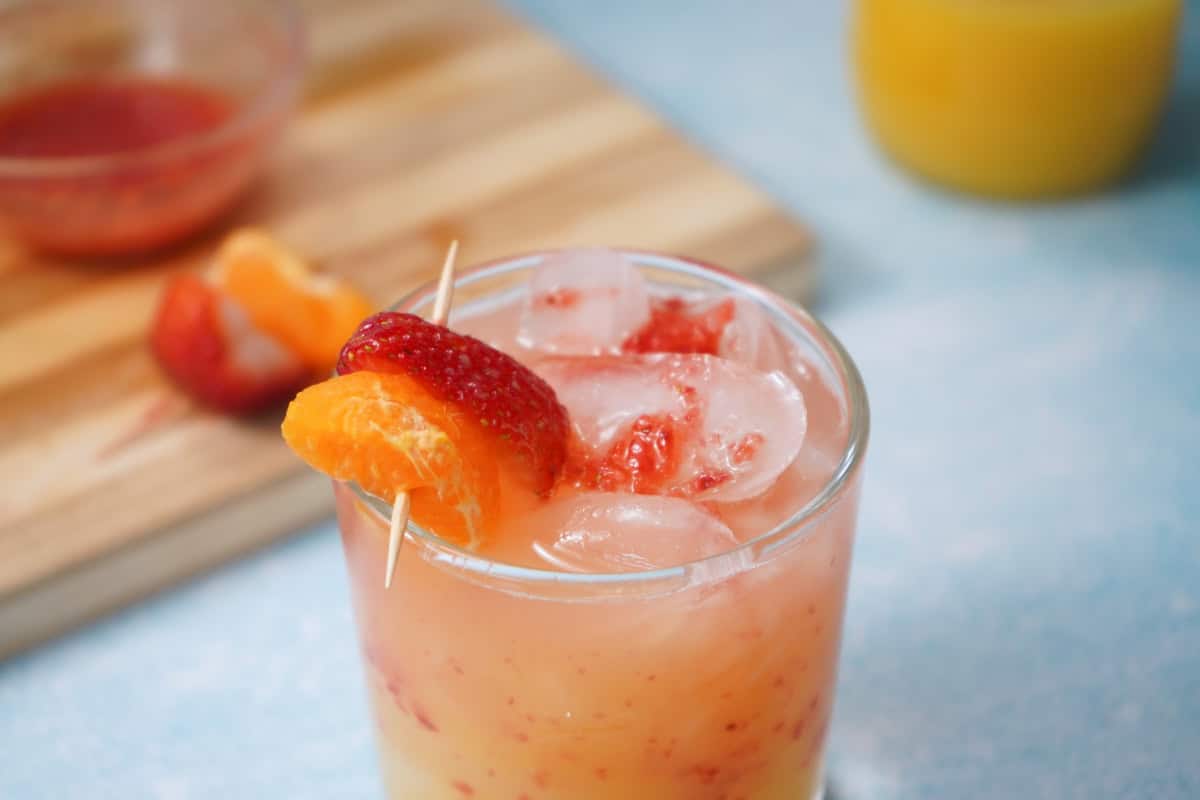 Strawberry Tequila Sunrise with blue backdrop