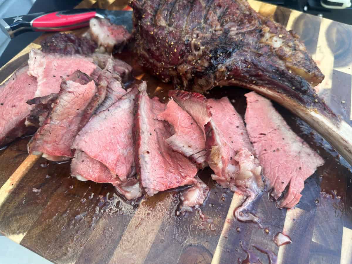 Tomahawk steak after sliced on cutting board.