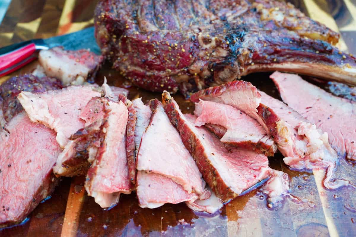 Sliced tomahawk on cutting board
