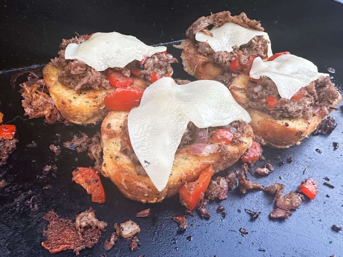 texas toast with shaved steak on blackstone.