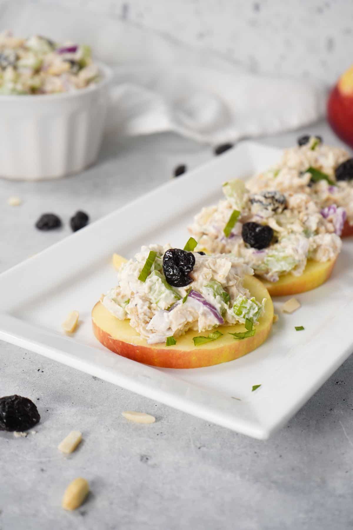 Cherry chicken salad on top of 3 apple slices.