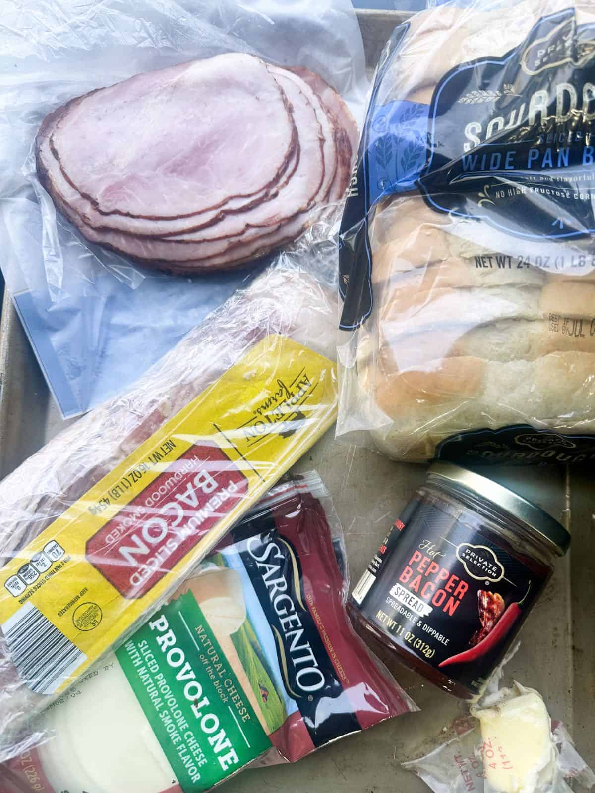 Ingredients needed for the sandwiches on a baking sheet. 