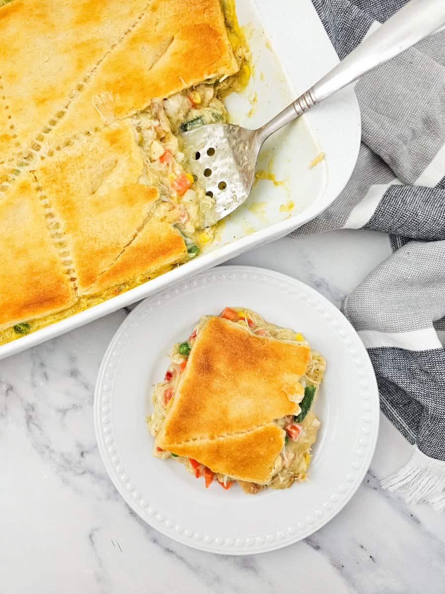 One slice removed of a chicken pot pie casserole.